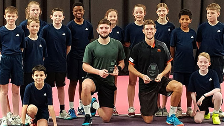 Neil Pauffley and Sean Hodkin with their awards and a group of young boys and girls