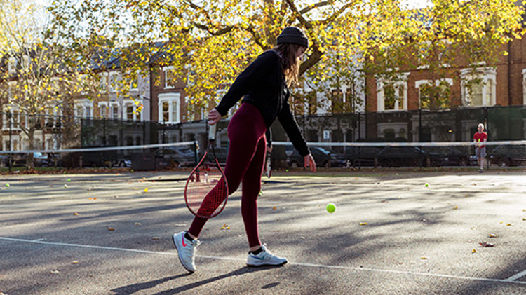 Woman playing tennis in a park