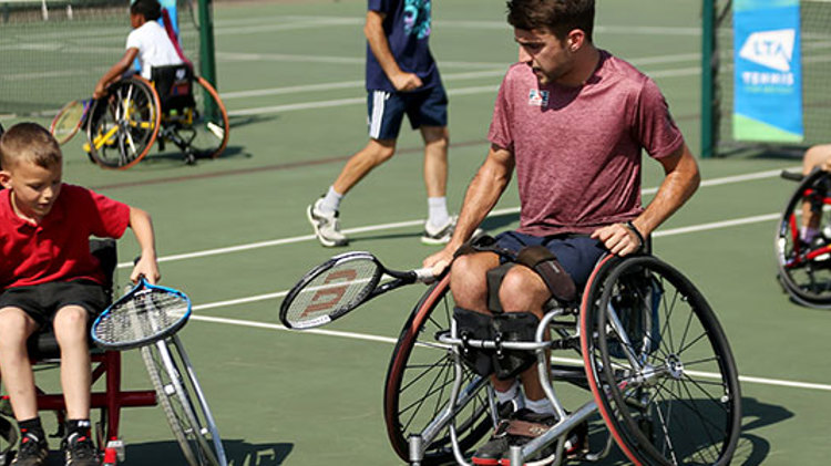 wheelchair adults and juniors rackets in hand practicing skills on tennis courts  
