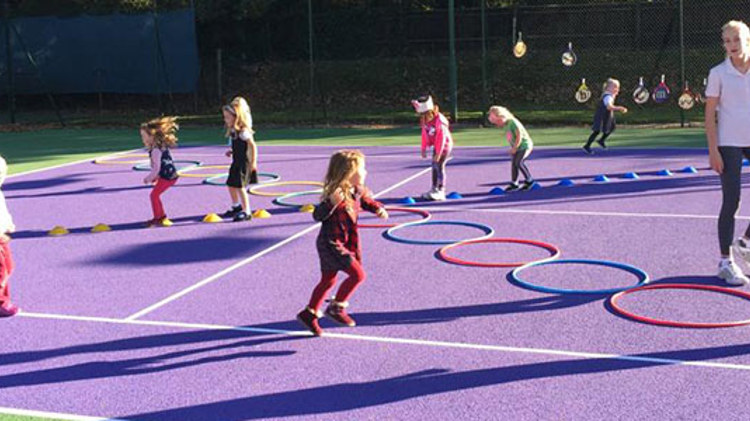 LTA regional award winner Maggie coaching kids