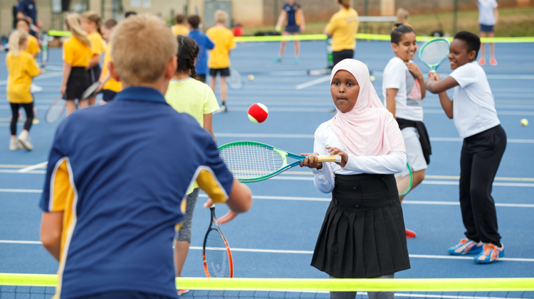 Young boy and girl playing tennis at the tennis festival in Bristol