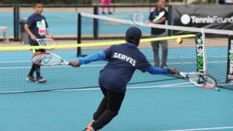Tennis serves friendly junior match