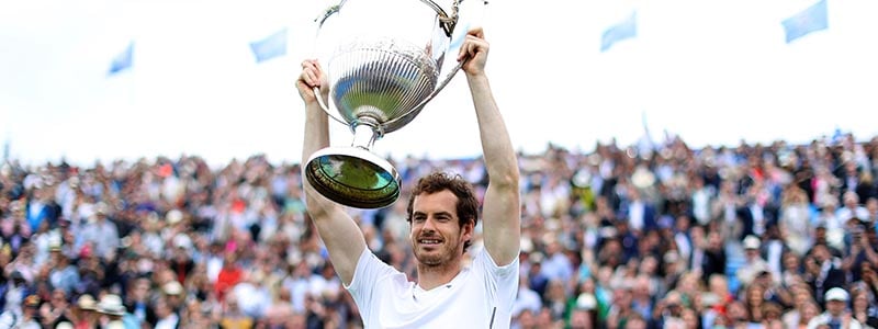 Andy Murray lifting a trophy after winning the men's final at Queens in 2016