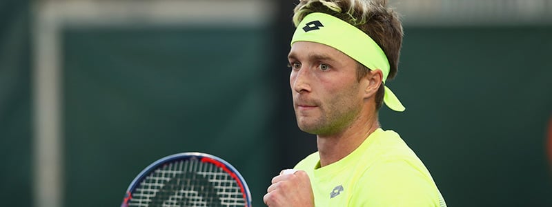 Liam Broady celebrating in his tennis gear