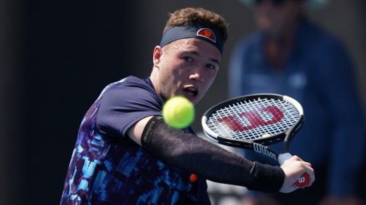 Alfie Hewett on court about to hit a backhand shot