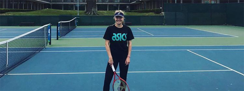 Harriet Dart smiling on tennis court at the NTC