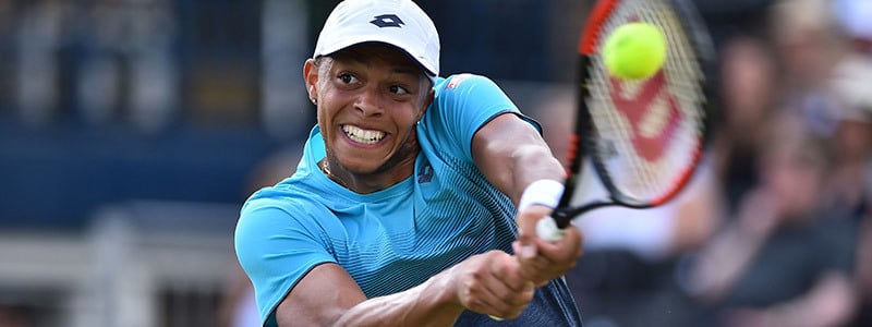 Jay Clarke playing a two-handed backhand
