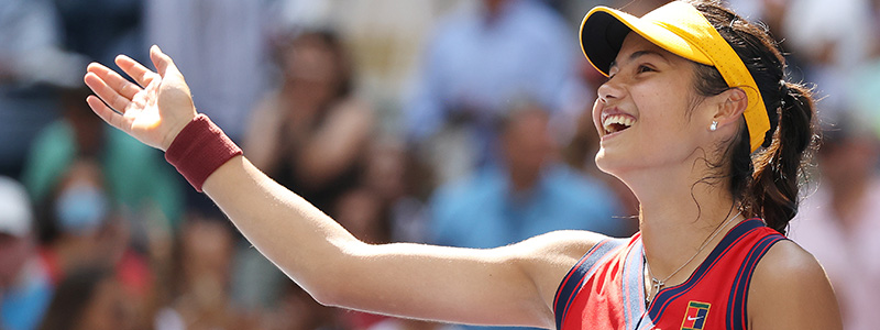close up of emma raducanu smiling and waving hand out