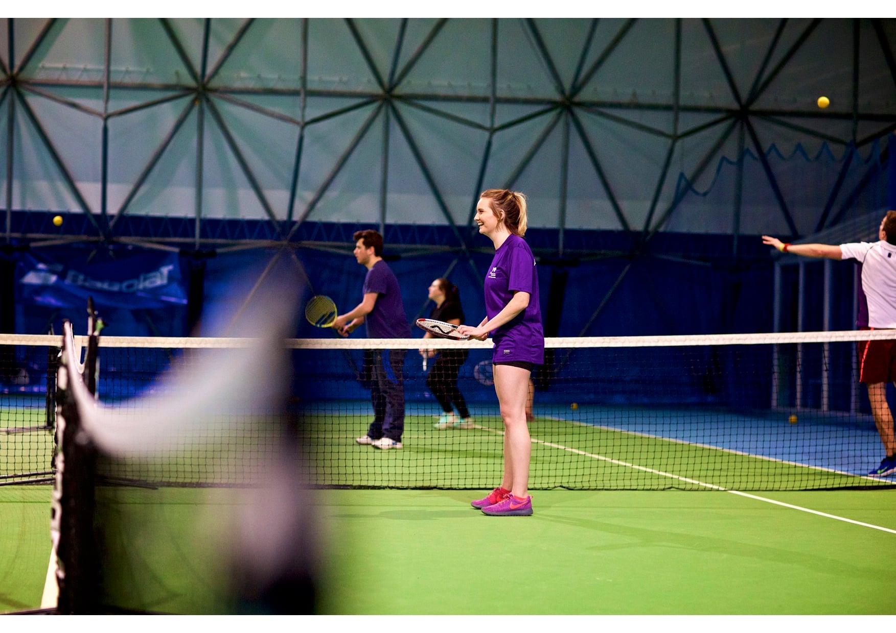 Emma playing on an indoor court