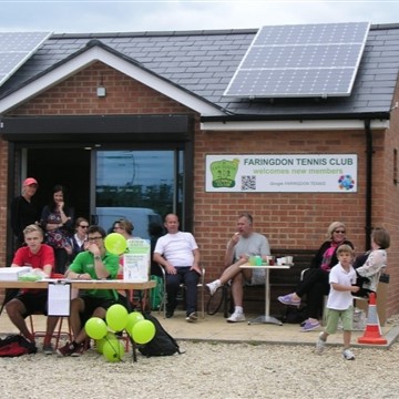 Members of Farringdon tennis club sitting outside their clubhouse