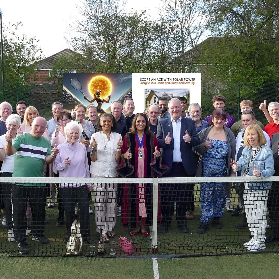 Members of Harrow Weald lawn tennis club posing with their thumbs up behind the net